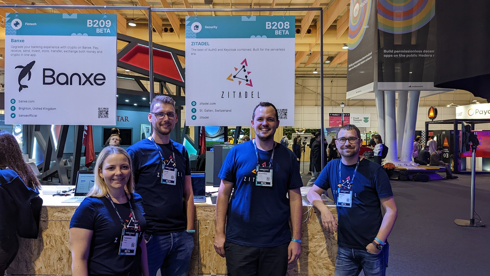 Fabienne, Silvan, Max, and Florian in front of our ZITADEL booth at Websummit